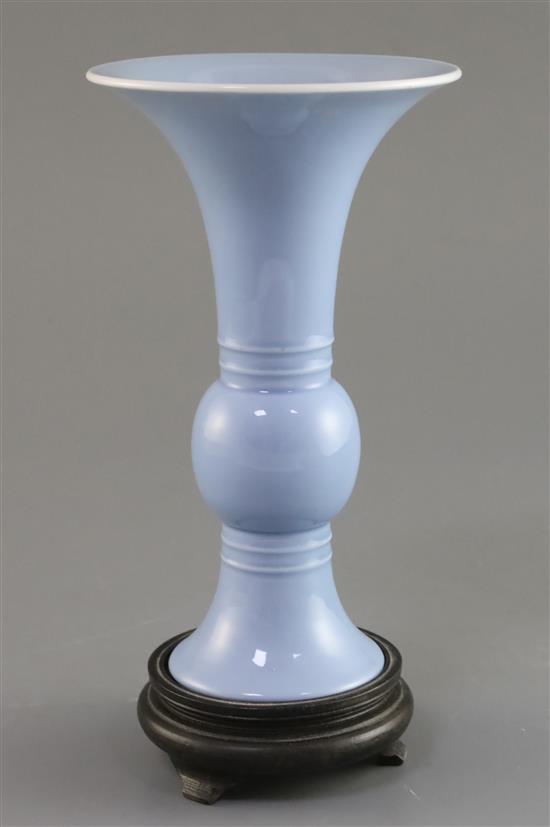 A Chinese clair de lune trumpet vase, gu, Qing dynasty, H. 17.5cm, wood stand